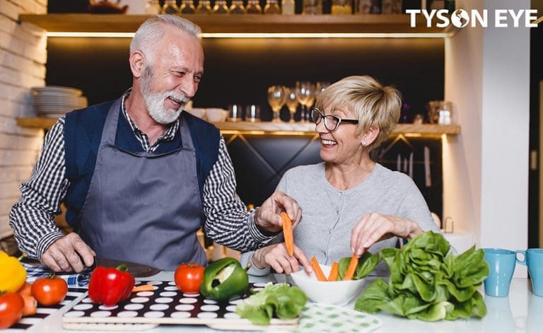 Couple cooking together and smiling about how nutrition affects vision