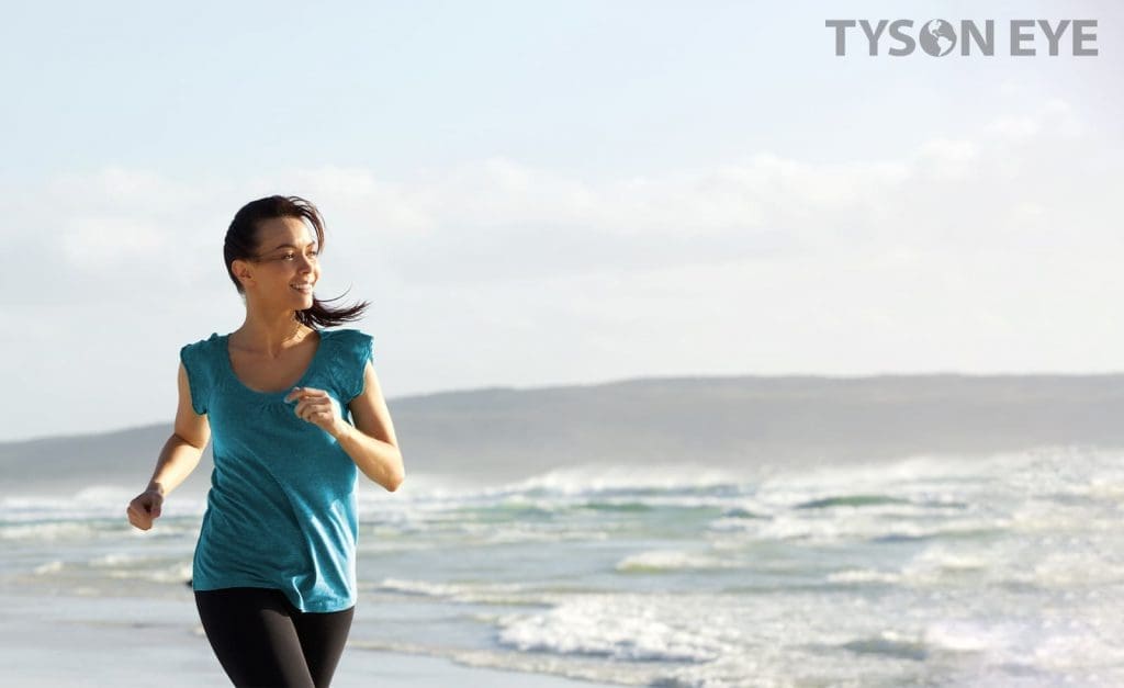 person running on the beach and understanding how LASIK works