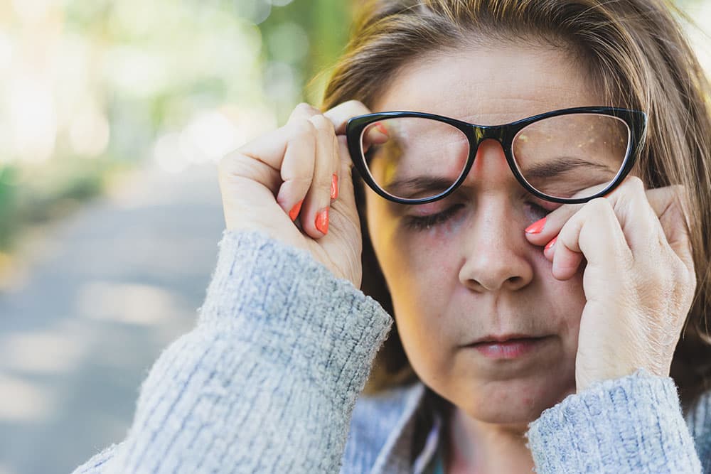 A woman suffering from dry eyes from allergies