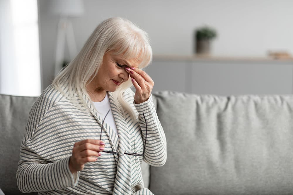 A woman with eye pain from dry eyes