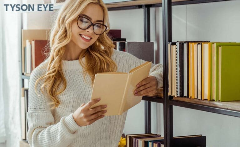 person reading a book with glasses to show the gift of LASIK surgery