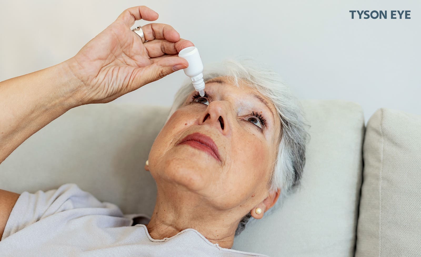How to recognize and treat dry eye. Woman using eye drops for dry eyes.